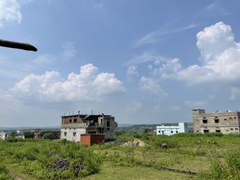 Houses on field against sky