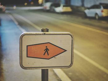 Close-up of road sign on street