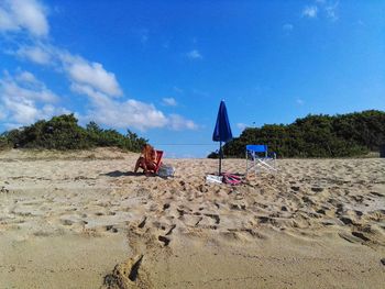 Scenic view of beach against blue sky