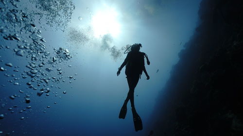 Low angle view of man in sea against sky