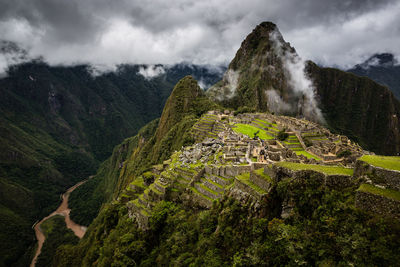 Scenic view of mountain range against cloudy sky