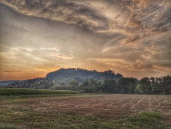 Scenic view of field against sky during sunset