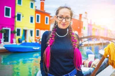 Portrait of young woman standing in boat