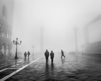 People at piazza san marco in foggy weather