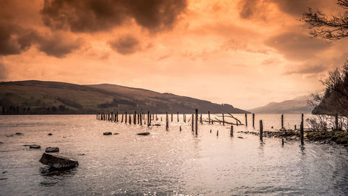 Scenic view of lake against sky during sunset