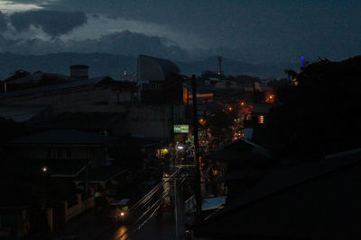 High angle view of illuminated buildings against sky at night