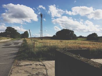 Road by landscape against sky