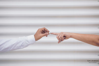 Midsection of couple holding hands