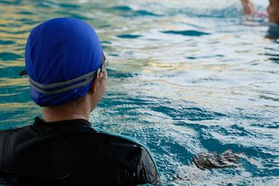 Rear view of man swimming in sea