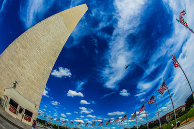 Low angle view of buildings against cloudy sky