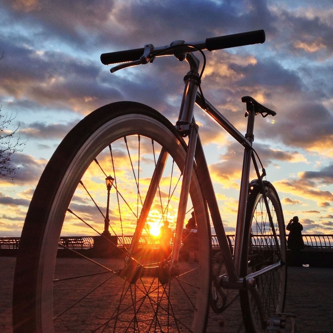 sunset, sky, cloud - sky, silhouette, transportation, orange color, mode of transport, bicycle, sun, land vehicle, stationary, cloud, cloudy, wheel, parking, dramatic sky, sunlight, no people, parked, outdoors