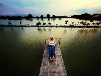 Rear view of man standing in lake