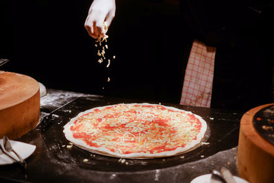 Close-up of pizza served in kitchen