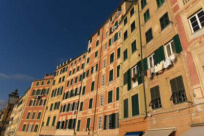 Low angle view of residential building against blue sky