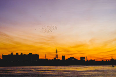 Silhouette of city at sunset