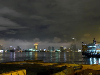 Illuminated cityscape against clear sky at night