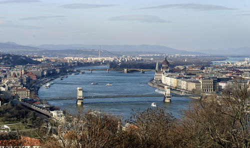 High angle view of bridge over river and buildings in city