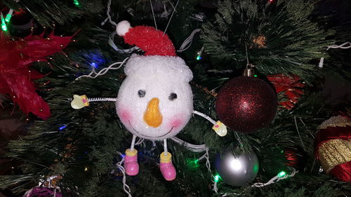 Christmas decoration hanging on tree at night