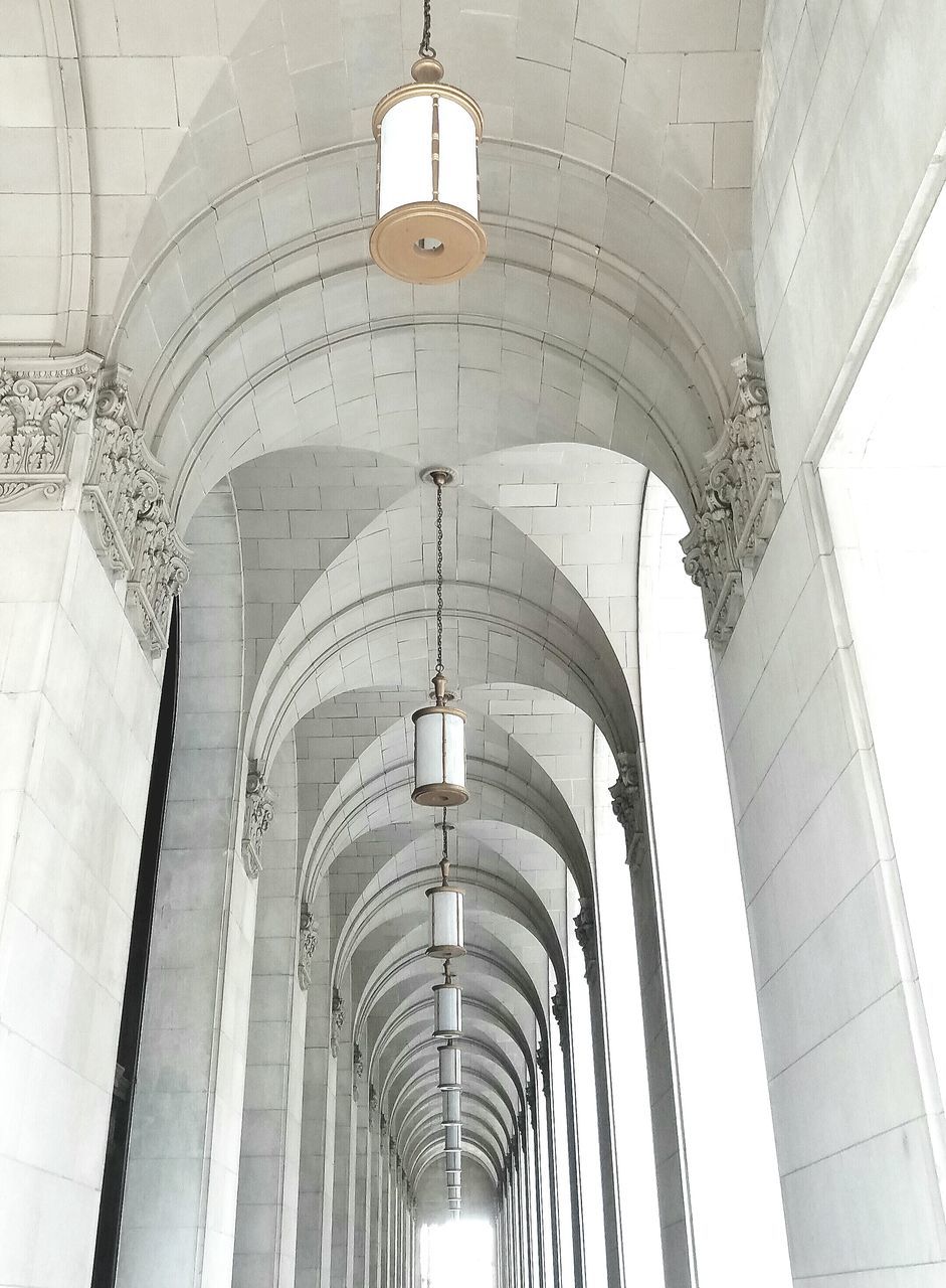 architecture, built structure, low angle view, arch, indoors, ceiling, lighting equipment, building exterior, architectural column, hanging, architectural feature, day, famous place, no people, building, history, travel destinations, design, wall - building feature, ornate