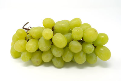 Close-up of grapes over white background