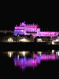 Reflection of illuminated buildings in water at night