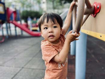 Portrait of boy playing in playground outdoors