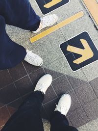 Low section of man standing on tiled floor