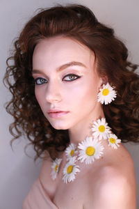 Side view portrait of teenage girl wearing flowers