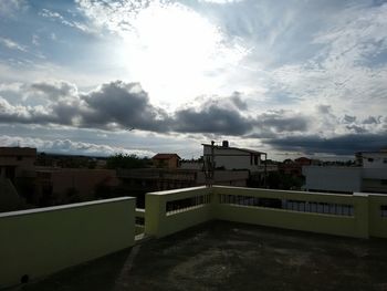 Buildings against cloudy sky