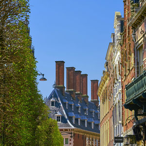 Low angle view of buildings against blue sky
