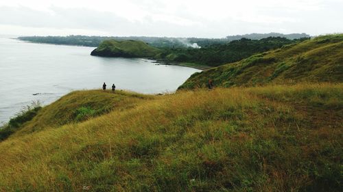 Scenic view of cloudy sky over green landscape