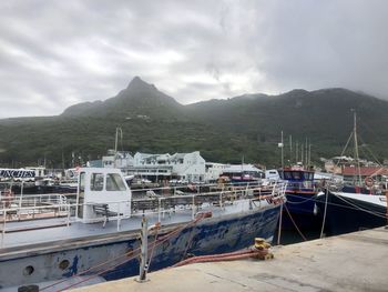 View of marina at harbor against mountains