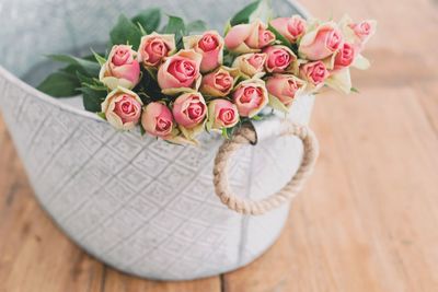 High angle view of pink roses in basket