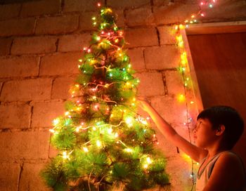 Person holding illuminated lantern