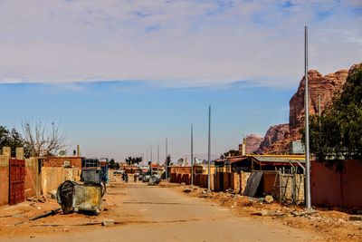Street amidst buildings in city against sky