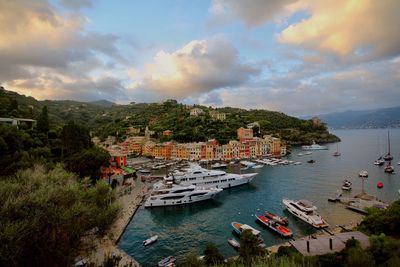 High angle view of townscape by sea against sky