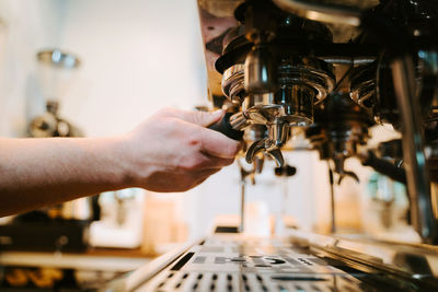 Midsection of man working at machine