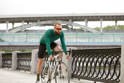 Side view of man riding bicycle