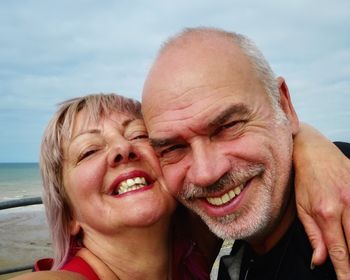 Portrait of elderly couple smiling while standing outdoors