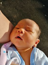 Close-up of cute baby sleeping outdoors