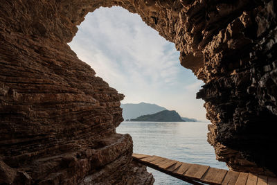 Scenic view of sea and mountains against sky