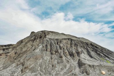 Low angle view of rock formation against sky