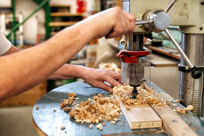 Midsection of carpenter working on table