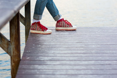 Low section of woman on wooden pier