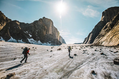 Rear view of explorers crossing the parade glacier, baffin island.