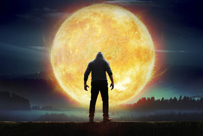 Digital composite image of man standing against sun at night