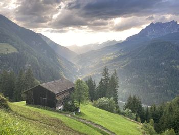 Scenic view of field and mountains against sky