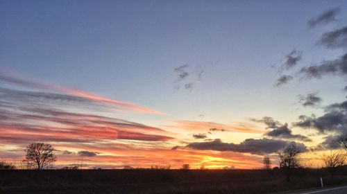 Scenic view of landscape against sky at sunset