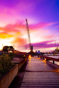 Sailboats in city at sunset