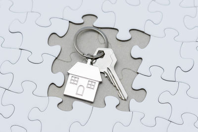 High angle view of house key on jigsaw puzzle